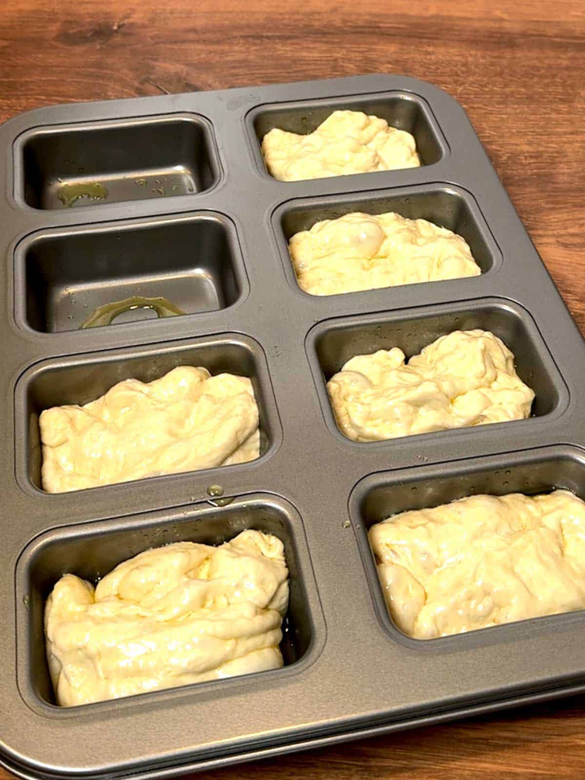 Dough in the cavities of the pan.