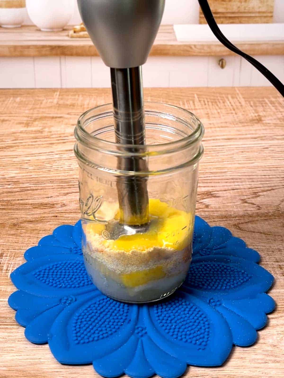 Blending base ingredients with immersion blender.