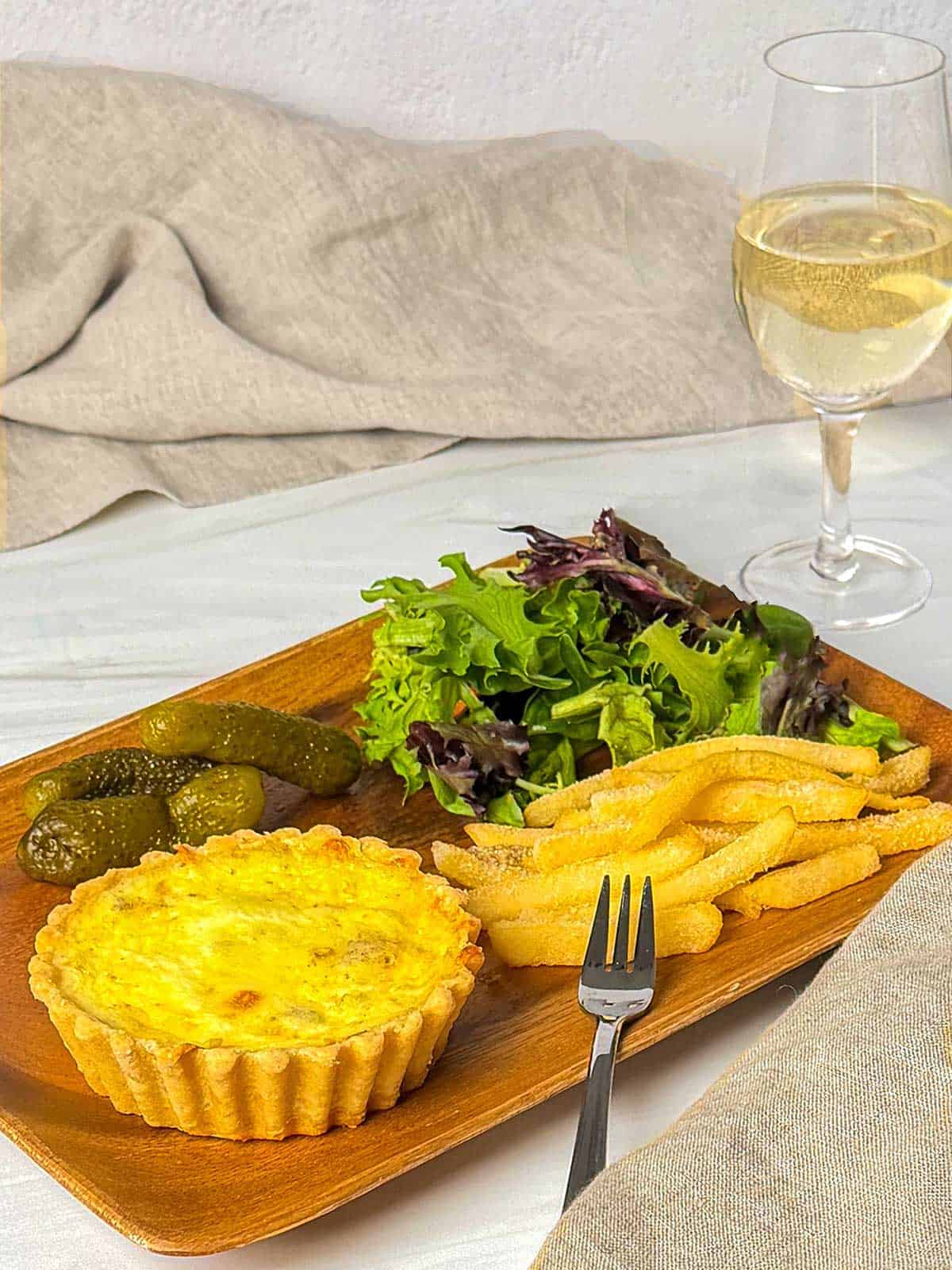 Mini Quiche Lorraine with fries and a salad.