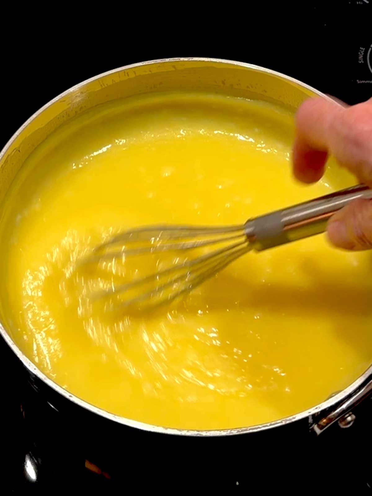 Whisking the lemon curd in the saucier.