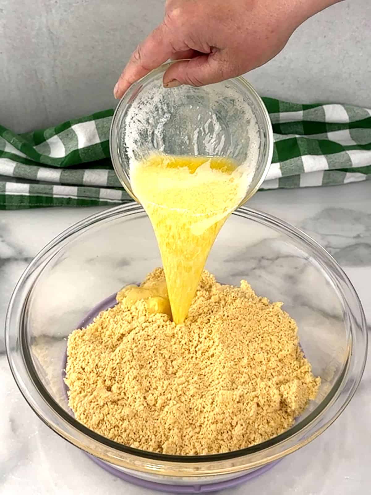 adding butter to cookie crumbs