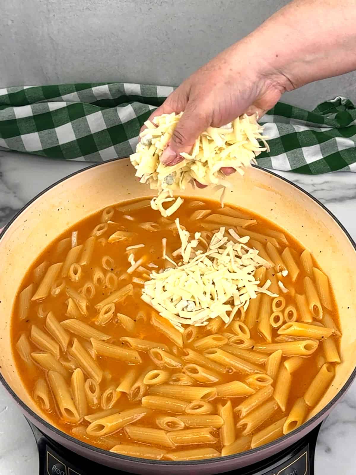 adding handfuls of cheese mixture