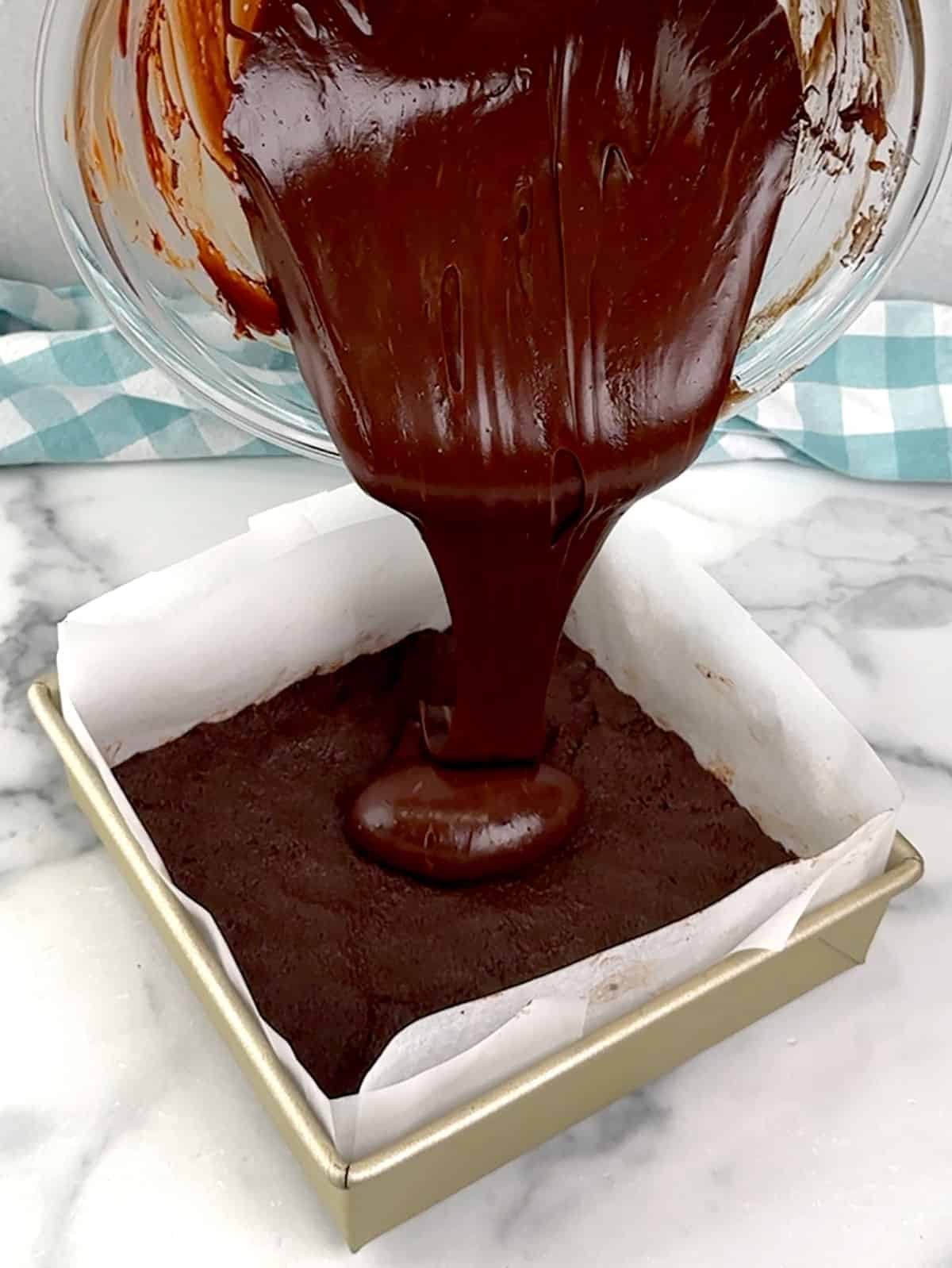 pouring filling into pan with prepared crust