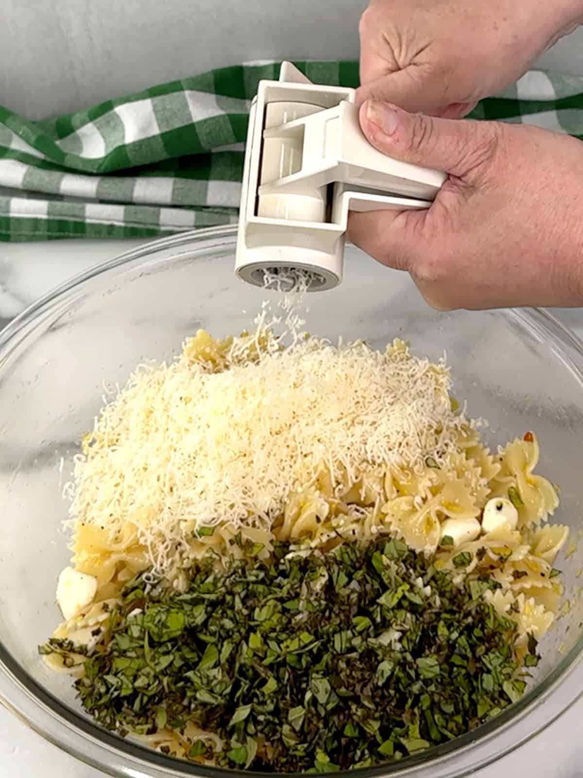 adding the chopped basil and grated Parmesan cheese.