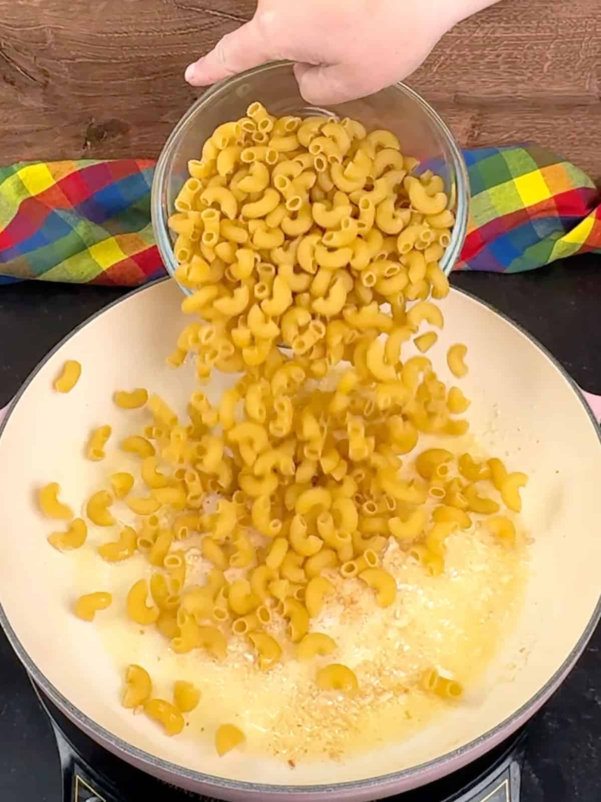 adding pasta to garlic butter