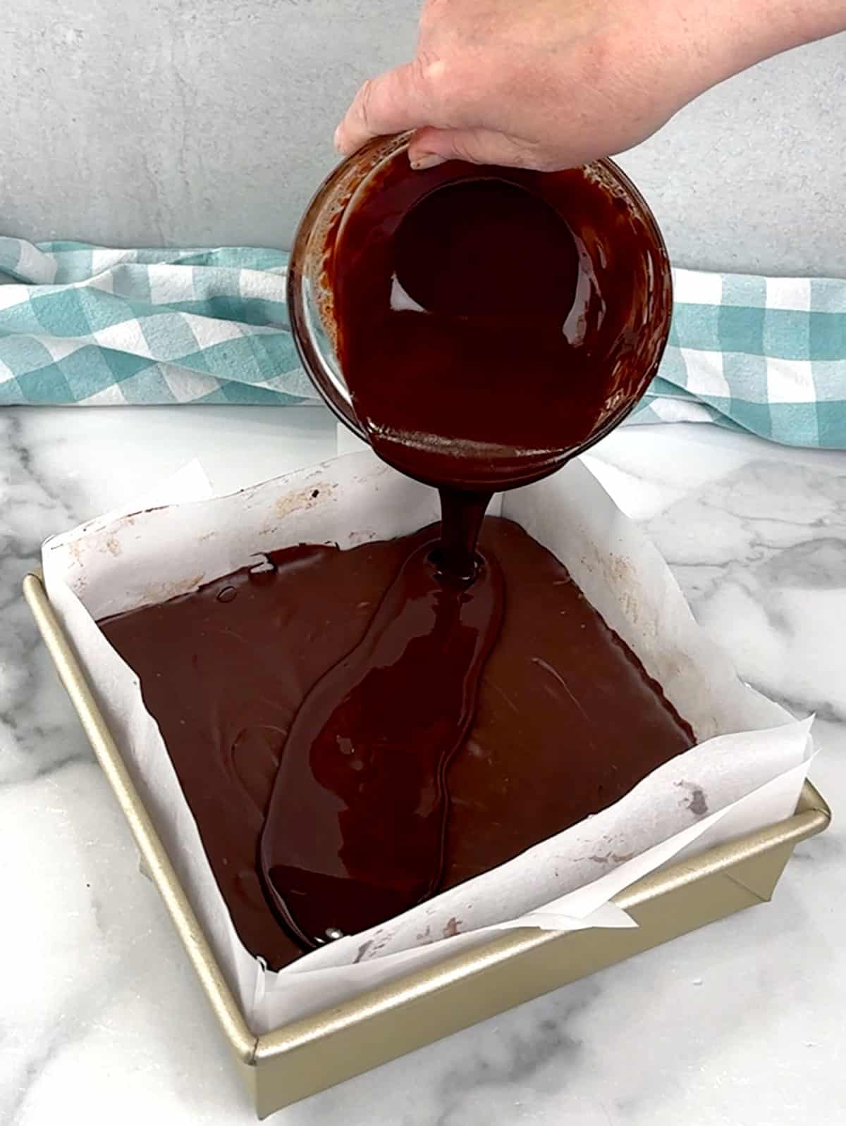 pouring topping over filling in pan