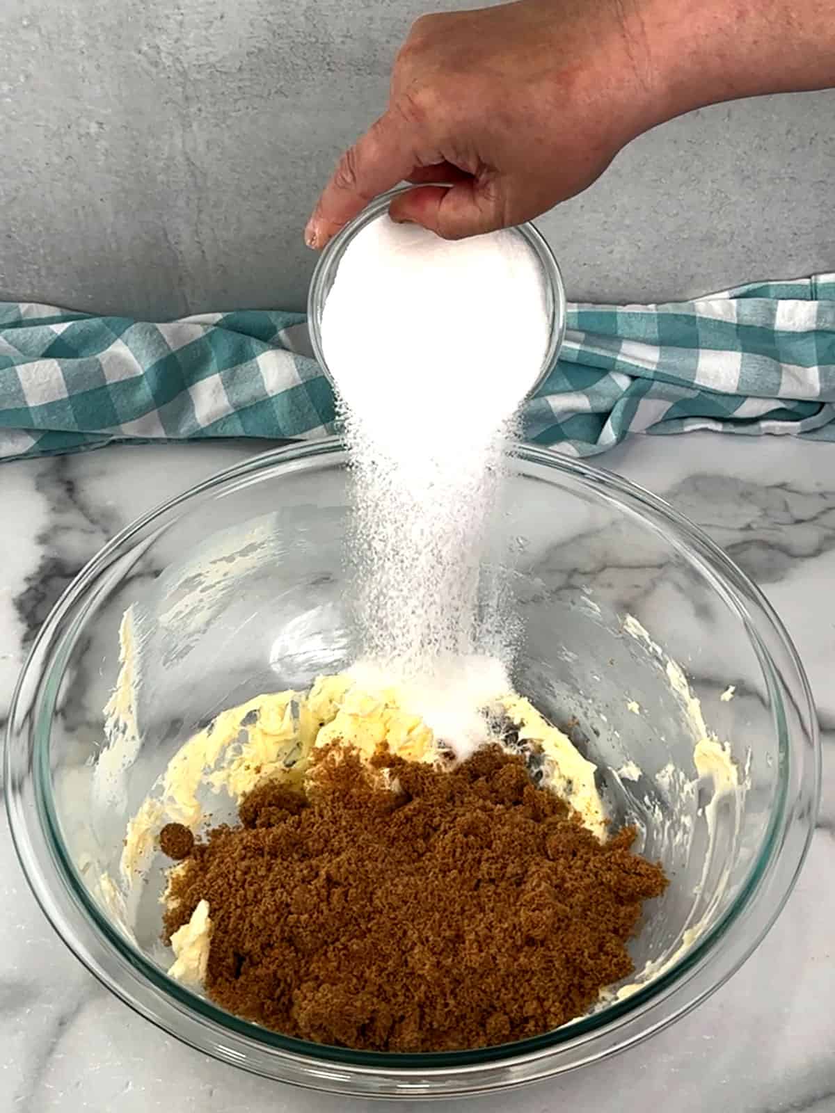 adding sugars to beaten butter