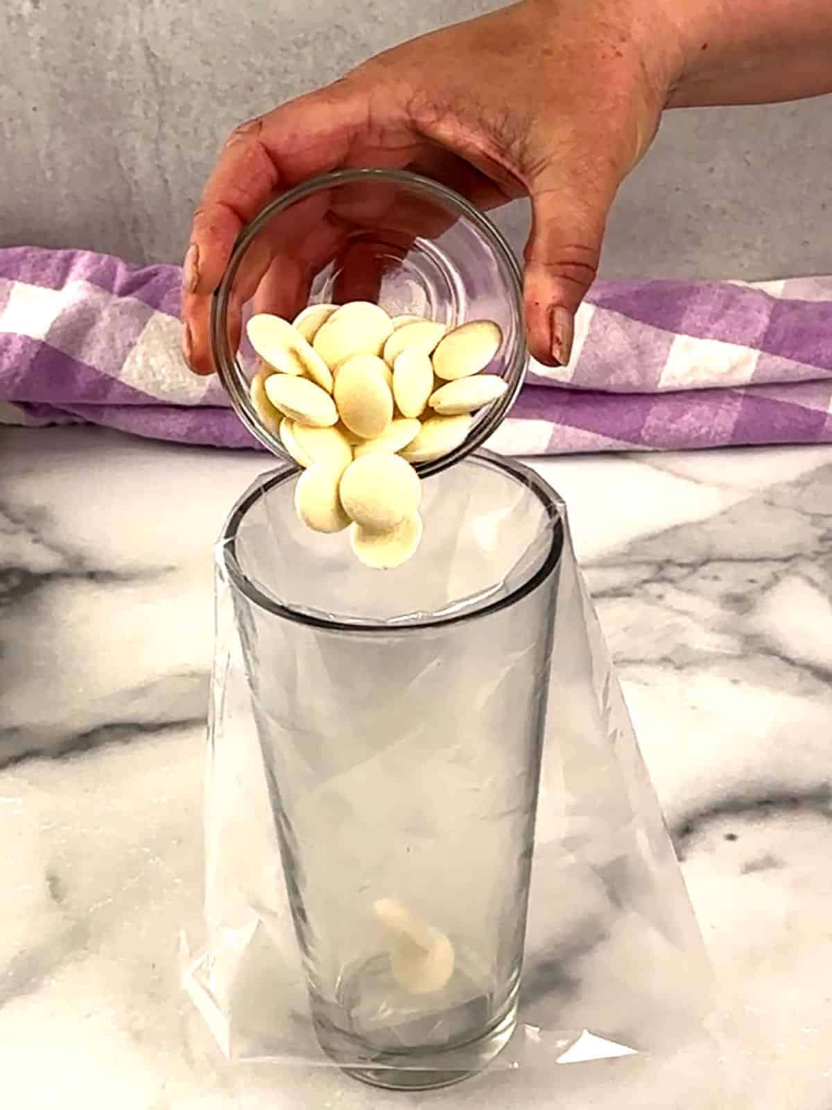 pouring melting wafers into piping bags before microwaving