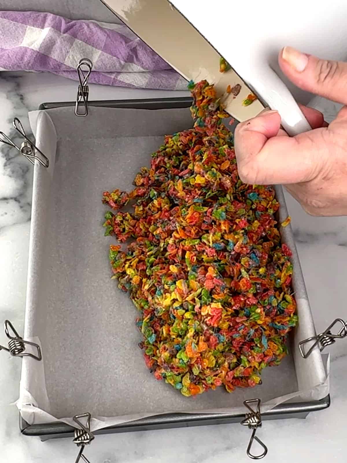 transferring cereal mixture to prepared pan