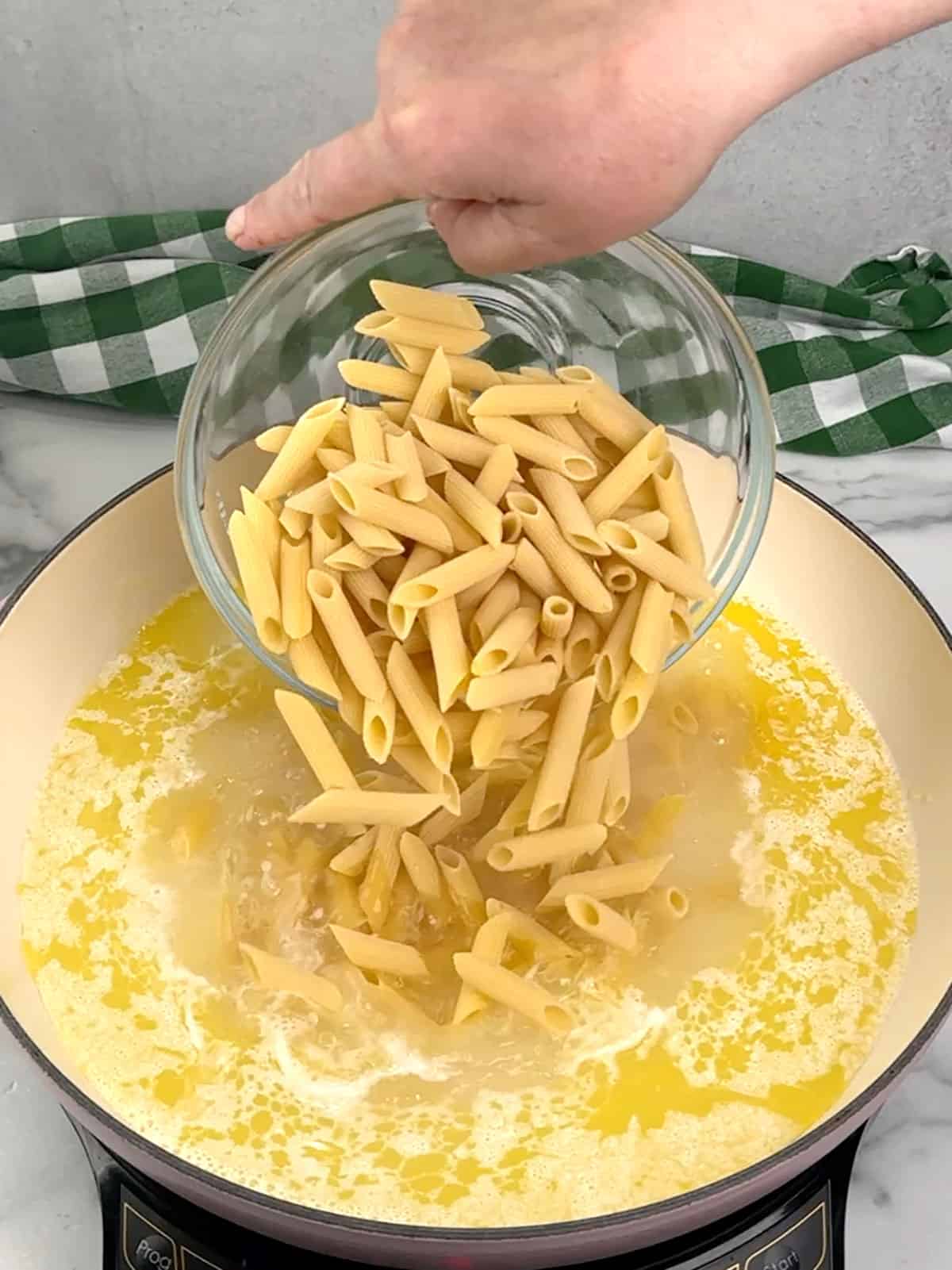 adding salt and pasta