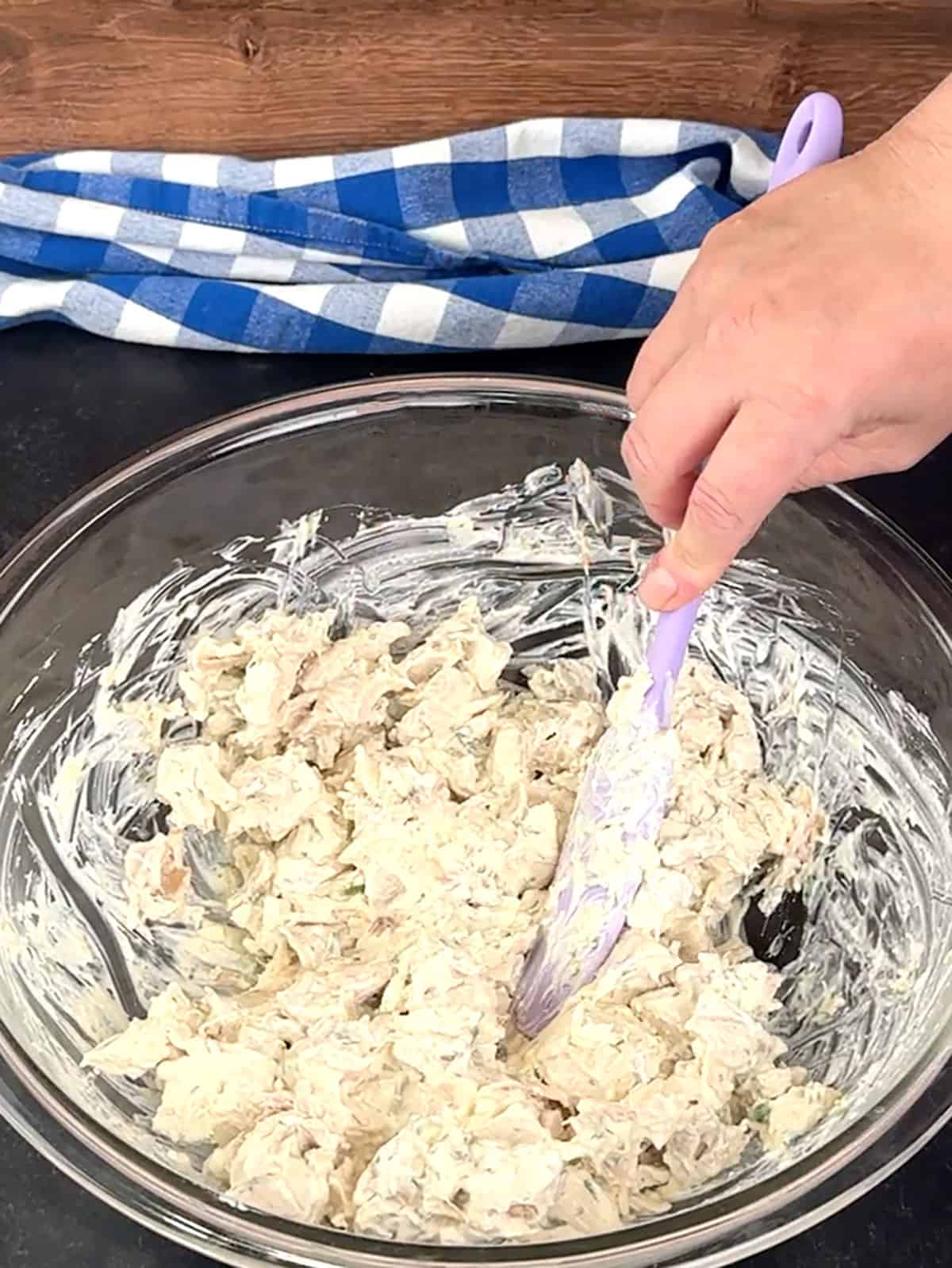 stirring almonds into chicken salad