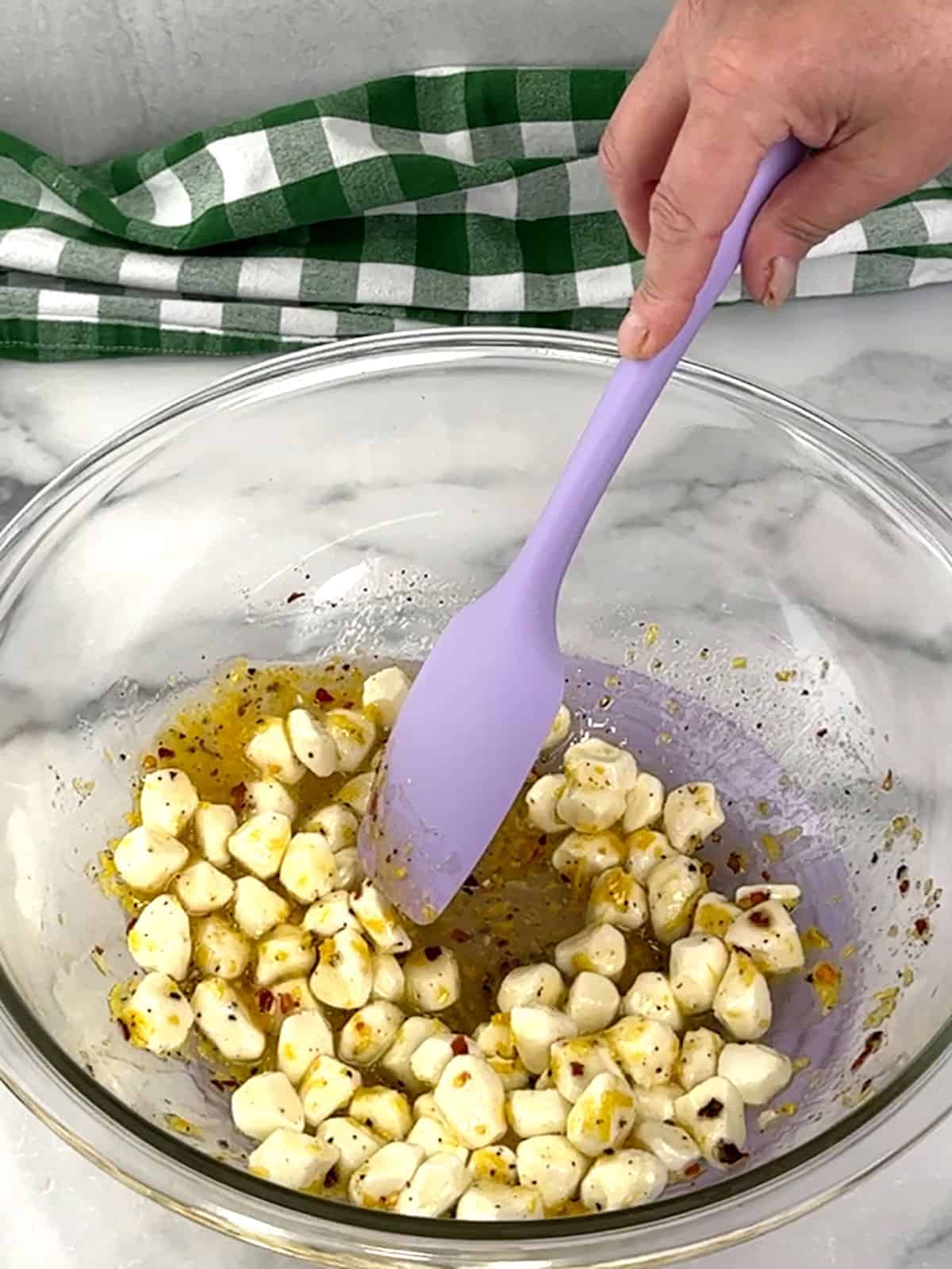 stirring mozzarella into dressing