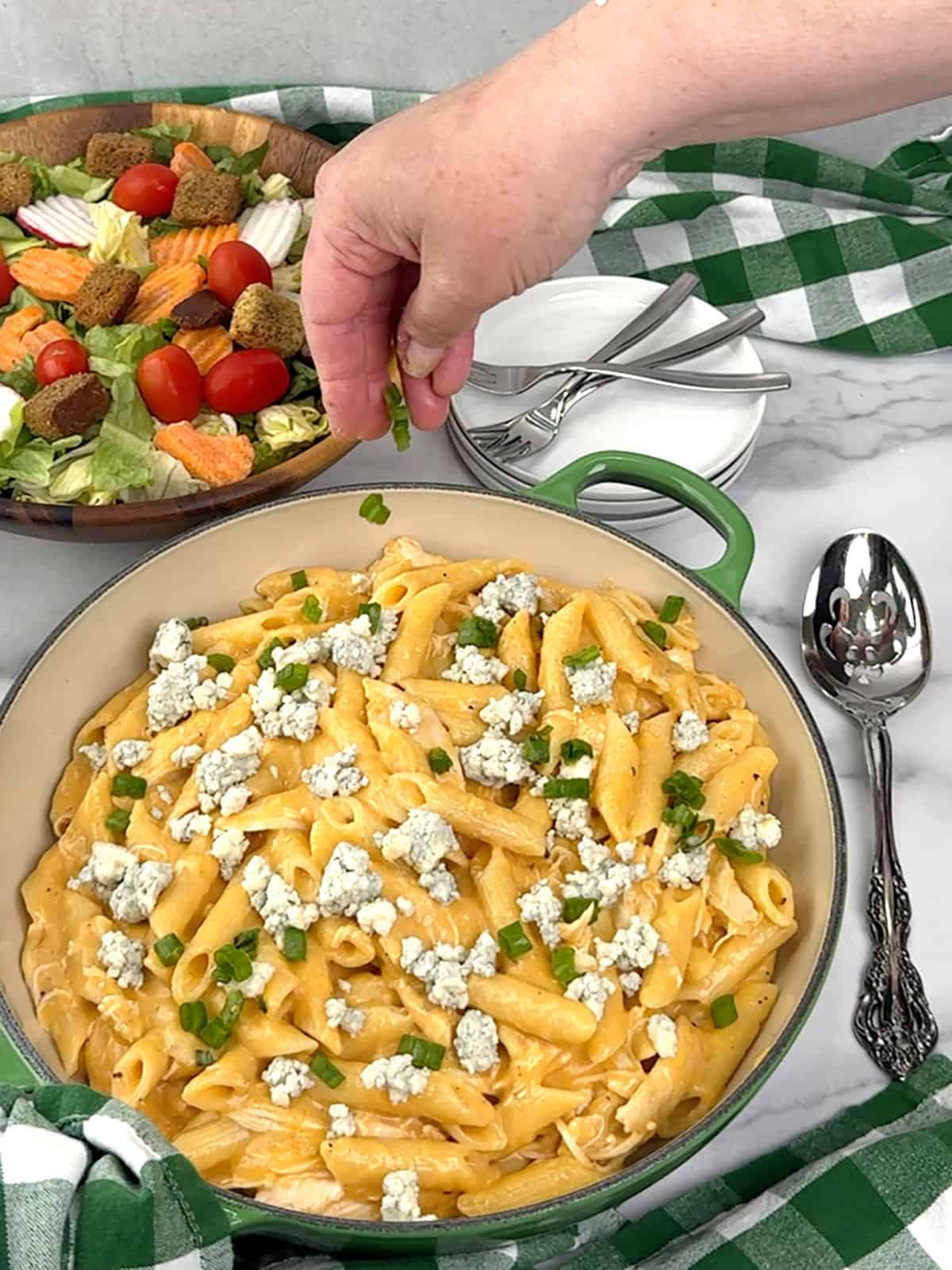 topping with blue cheese crumbles and green onions