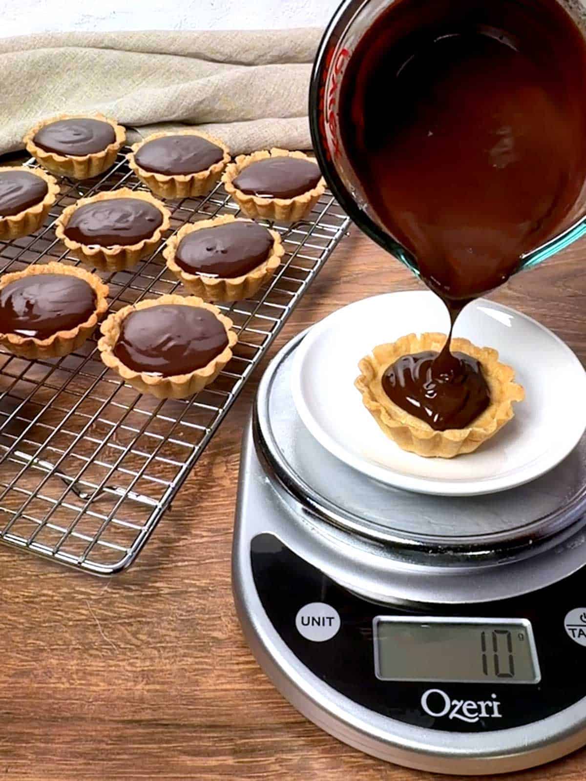 Adding ganache to the tart.
