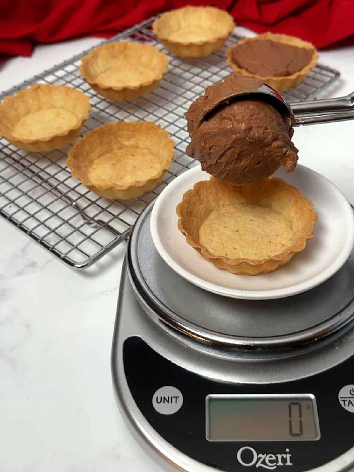 Filling the tart shell with chocolate mousse.