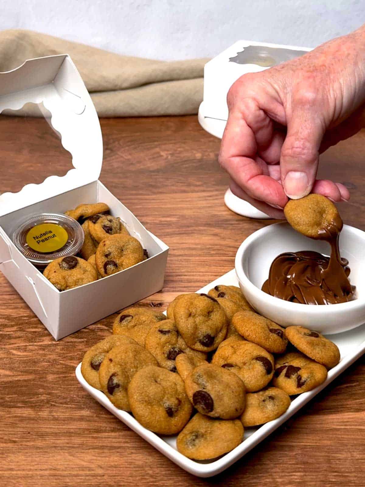 Dipping the mini cookie in Nutella Peanut.