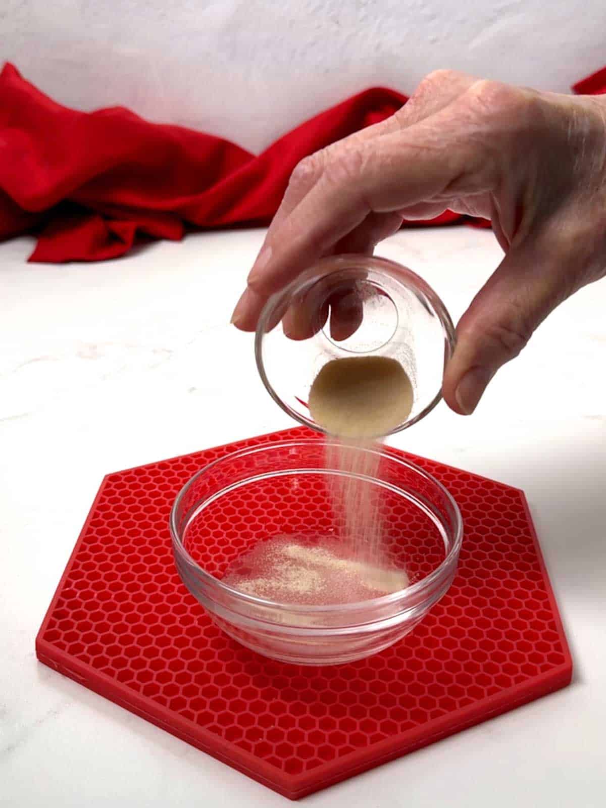 Adding gelatin to water in a small bowl.