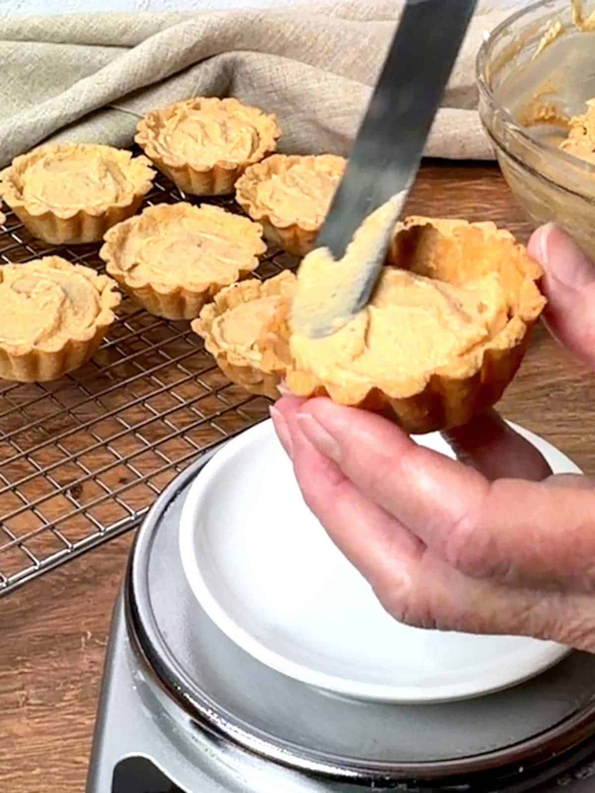 Smoothing the filling with a small offset spatula.