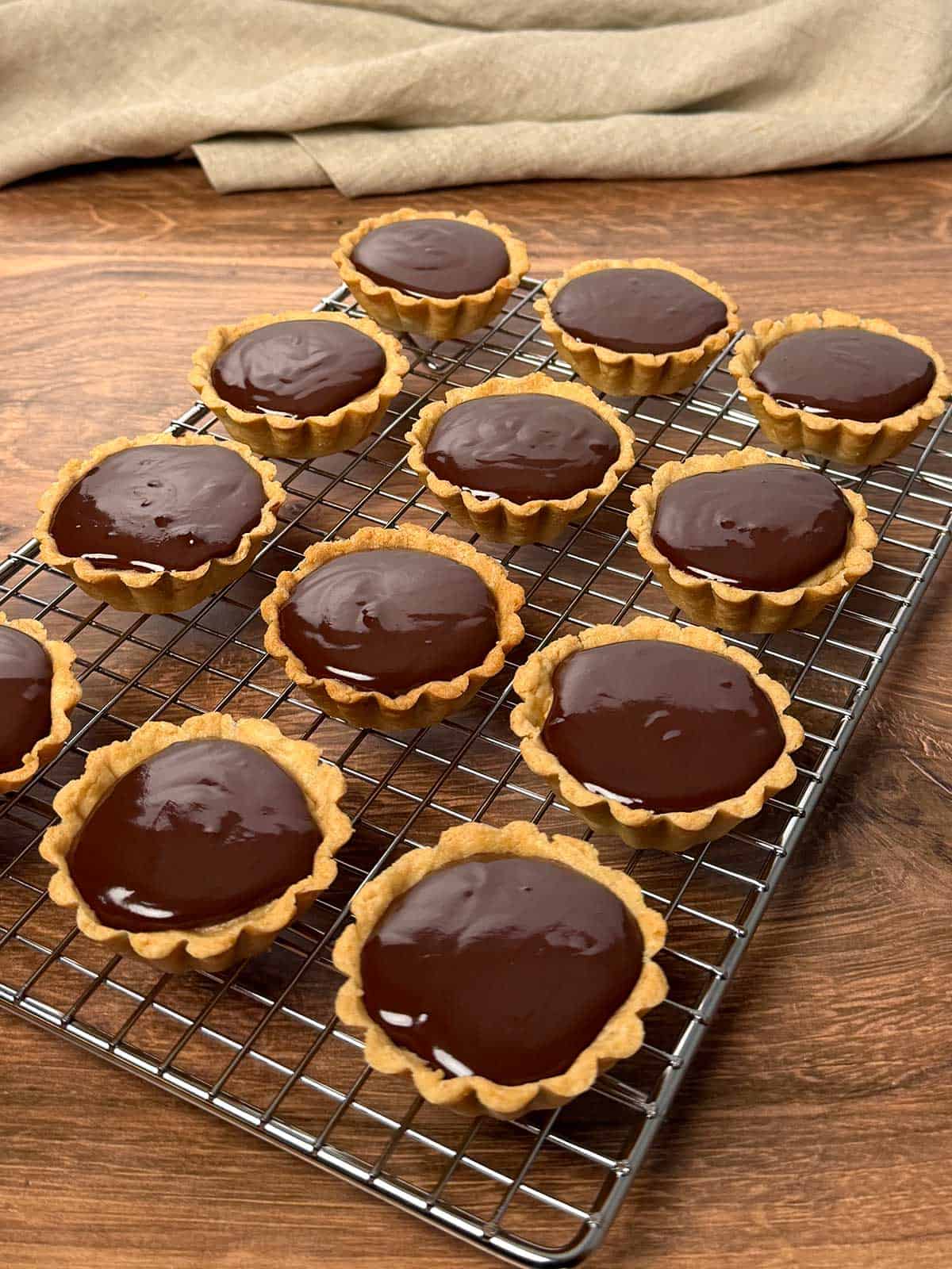 Finished tarts on a wire rack.