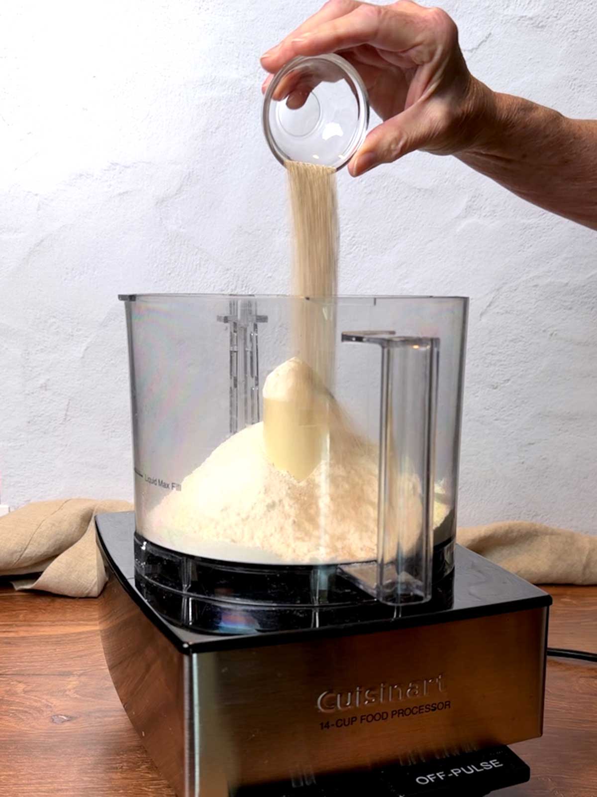 Adding yeast to the food processor.