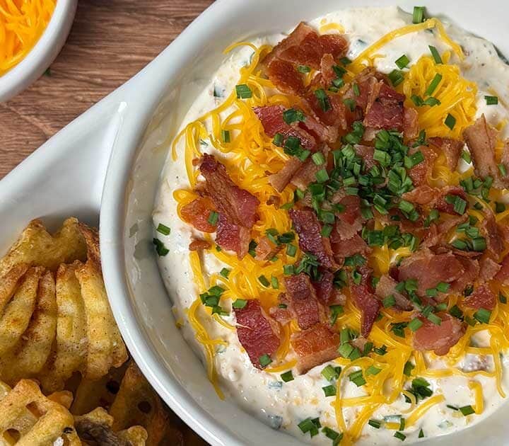 Loaded baked potato dip with waffle fries.