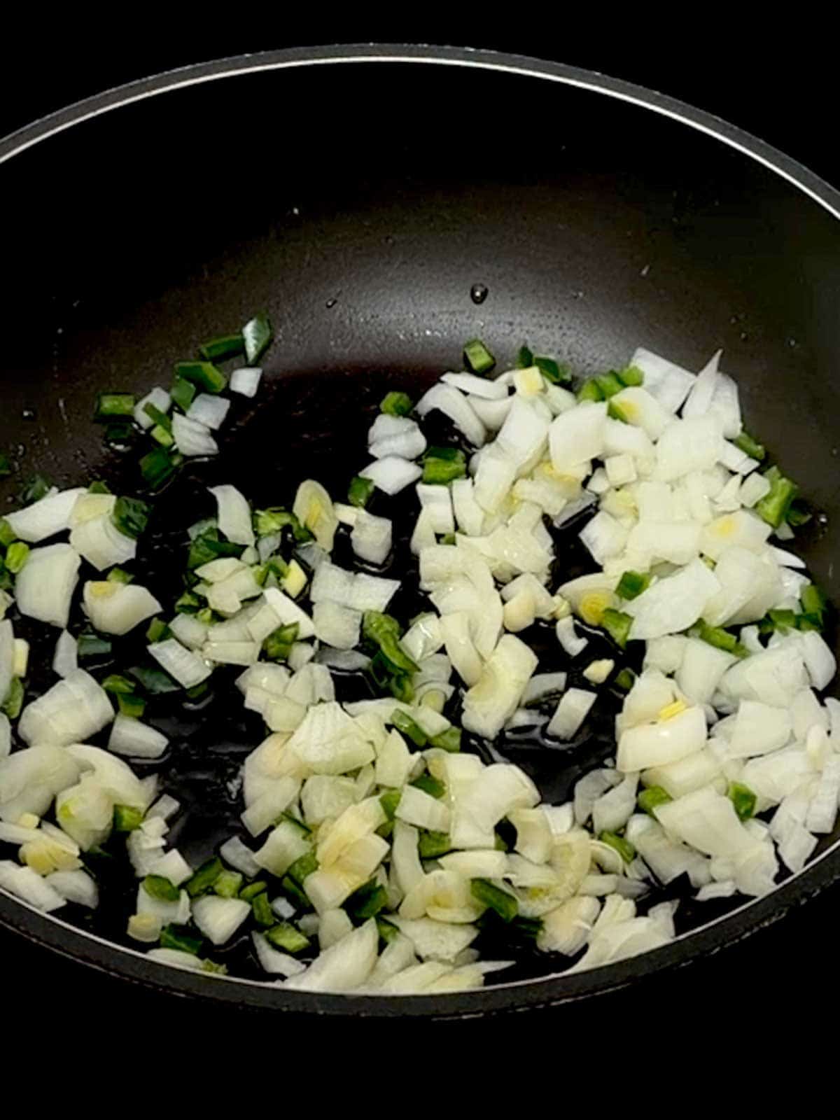 Onions and Jalapenos in a skilleet.