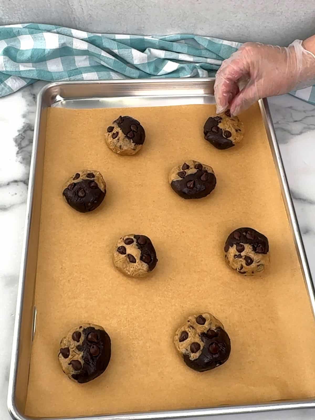 pressing chocolate chips into cookie dough