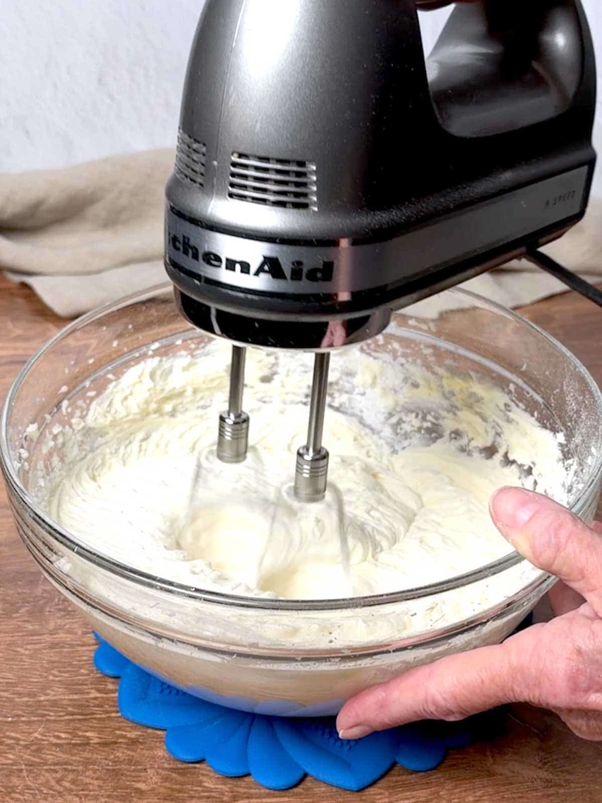 Beating the frosting ingredients until smooth and creamy.